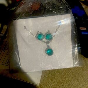 A blue silver and diamond necklace and earring set